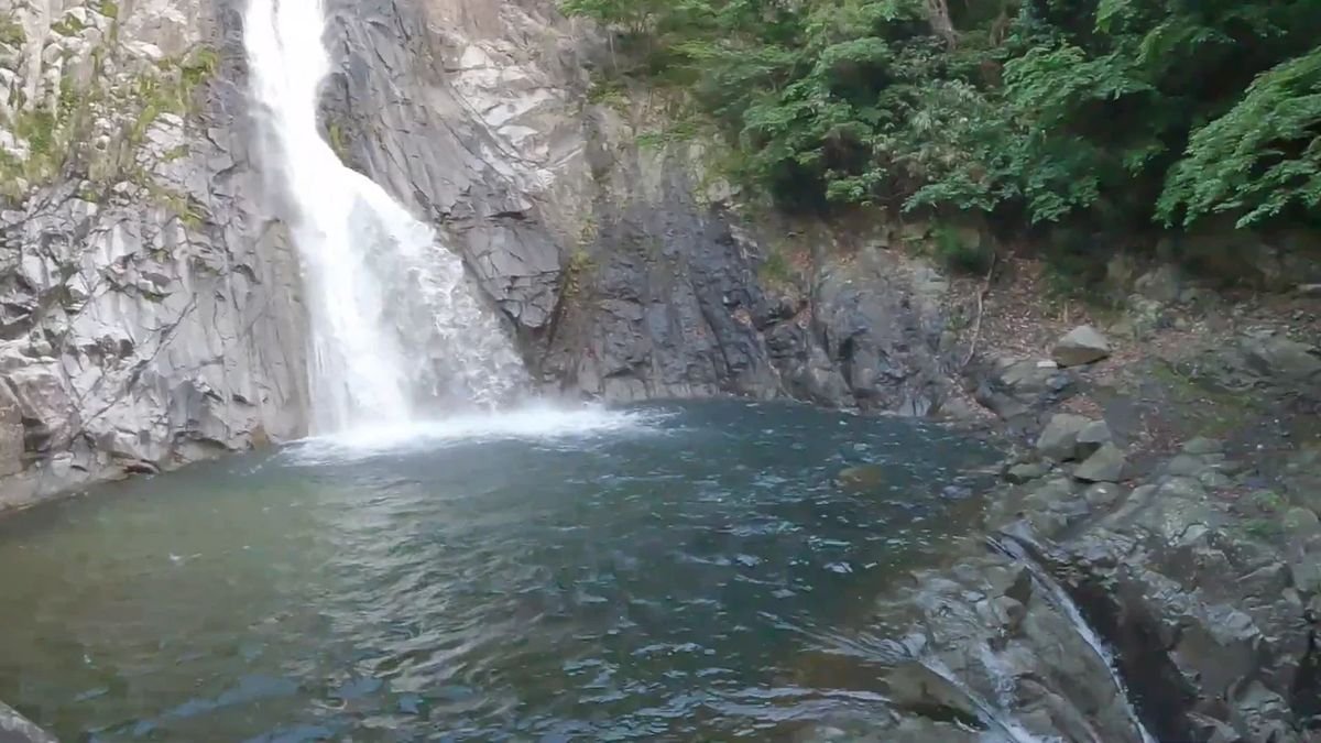 Waterfall into a rock pool, Japan